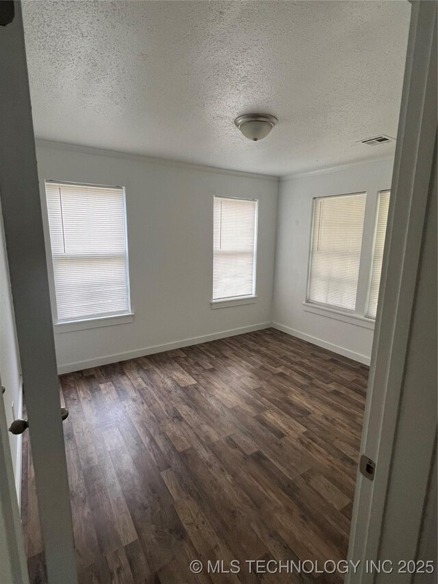 839 N New Haven Ave, Tulsa, OK 74115 - spare room with a textured ceiling and dark wood-style flooring
