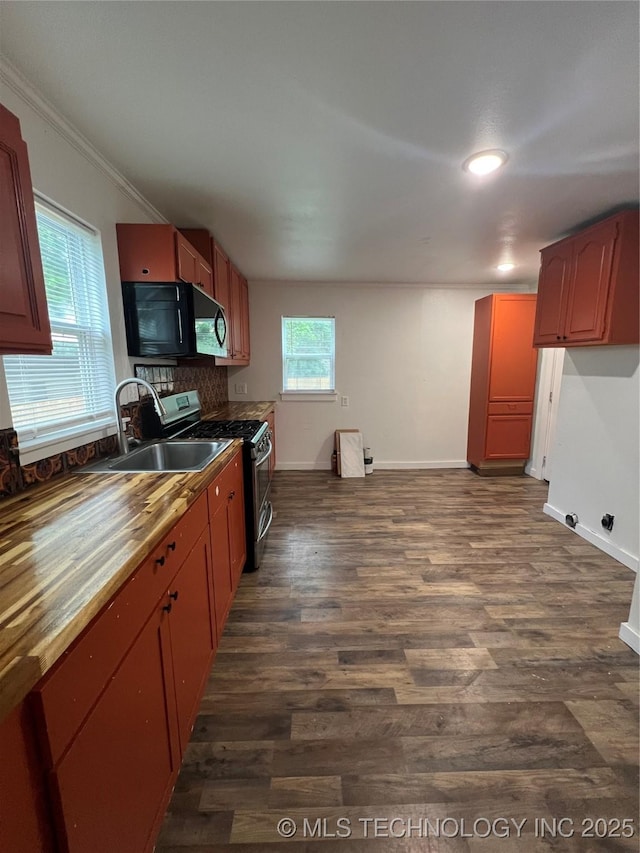 839 N New Haven Ave, Tulsa, OK 74115 - kitchen with black microwave, stainless steel gas range, dark wood-style floors, crown molding, and backsplash
