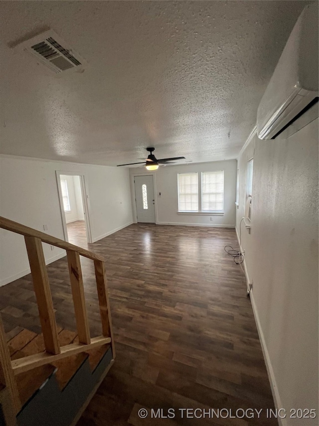 839 N New Haven Ave, Tulsa, OK 74115 - unfurnished room with wood finished floors, a wall mounted AC, ceiling fan, and a textured ceiling
