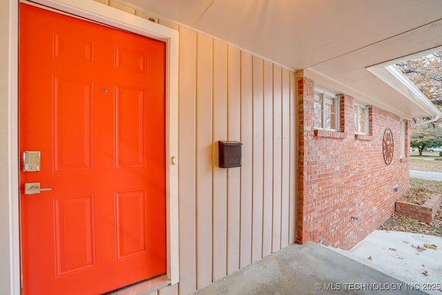 2441 S Norwood Ave, Tulsa, OK 74114 - view of exterior entry featuring board and batten siding and brick siding