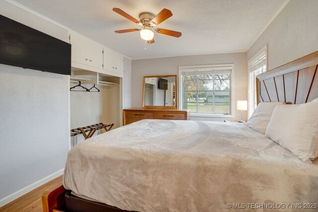 2441 S Norwood Ave, Tulsa, OK 74114 - bedroom featuring wood finished floors, ornamental molding, a closet, and a ceiling fan