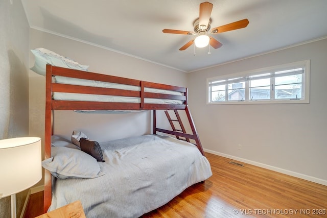 2441 S Norwood Ave, Tulsa, OK 74114 - bedroom with ornamental molding, wood finished floors, and a ceiling fan