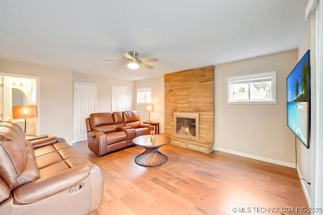 2441 S Norwood Ave, Tulsa, OK 74114 - living area featuring ceiling fan, plenty of natural light, light wood finished floors, and a fireplace