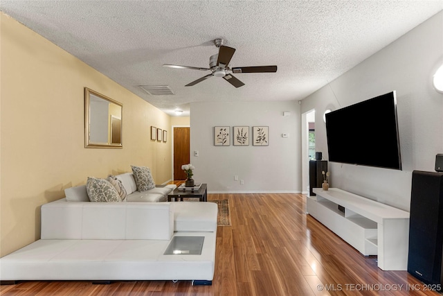 4504 S Cedar Ave, Broken Arrow, OK 74011 - living room featuring ceiling fan, wood finished floors, and a textured ceiling