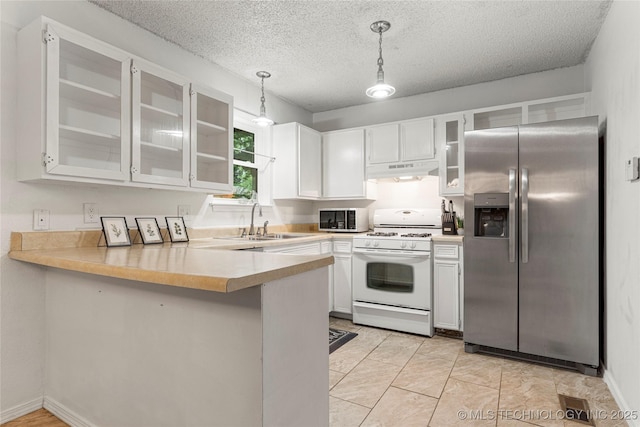 4504 S Cedar Ave, Broken Arrow, OK 74011 - kitchen featuring stainless steel fridge with ice dispenser, white gas stove, under cabinet range hood, a peninsula, and light countertops