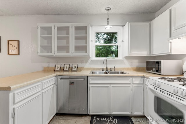 4504 S Cedar Ave, Broken Arrow, OK 74011 - kitchen with appliances with stainless steel finishes, a textured ceiling, white cabinets, light countertops, and glass insert cabinets