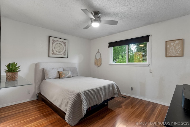 4504 S Cedar Ave, Broken Arrow, OK 74011 - bedroom featuring wood finished floors, a textured ceiling, and a ceiling fan