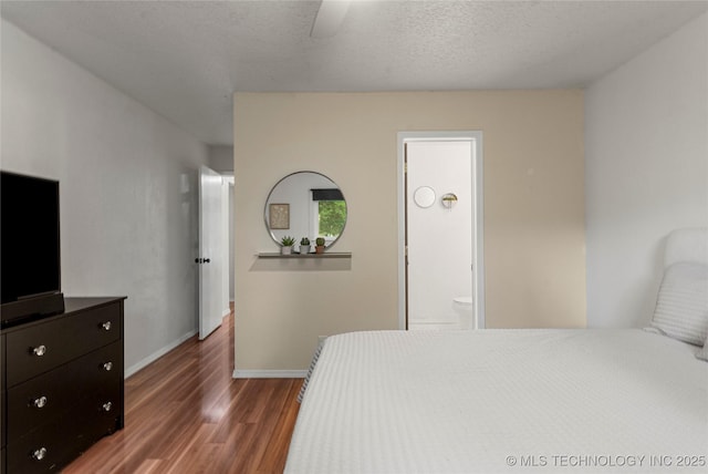 4504 S Cedar Ave, Broken Arrow, OK 74011 - bedroom with wood finished floors, ensuite bathroom, and ceiling fan