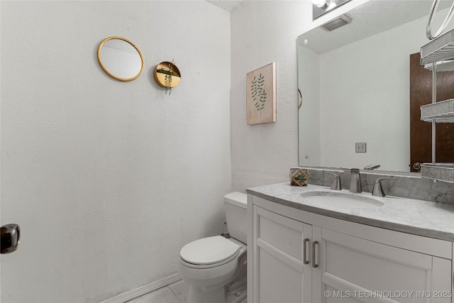 4504 S Cedar Ave, Broken Arrow, OK 74011 - bathroom featuring vanity, marble finish floors, and a textured wall