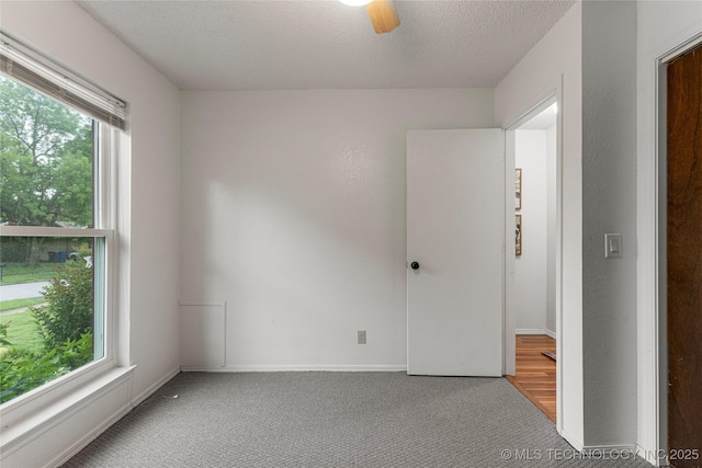 4504 S Cedar Ave, Broken Arrow, OK 74011 - empty room featuring carpet, a textured ceiling, and ceiling fan