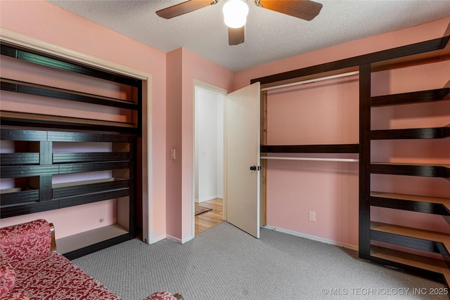 4504 S Cedar Ave, Broken Arrow, OK 74011 - unfurnished bedroom with carpet flooring, a textured ceiling, and ceiling fan
