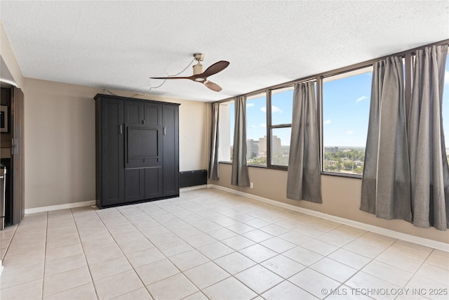 410 W 7th St Unit 1530, Tulsa, OK 74119 - unfurnished room featuring a textured ceiling, a ceiling fan, and light tile patterned flooring