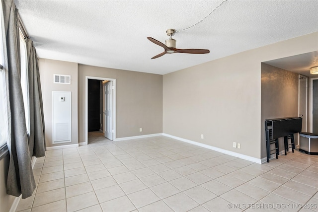 410 W 7th St Unit 1530, Tulsa, OK 74119 - unfurnished living room with a ceiling fan, a textured ceiling, and light tile patterned floors