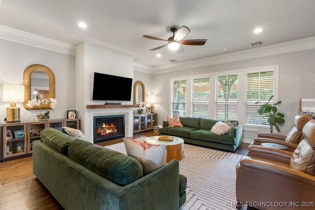 9402 E 109th St S, Tulsa, OK 74133 - living area with a ceiling fan, crown molding, wood finished floors, a lit fireplace, and recessed lighting