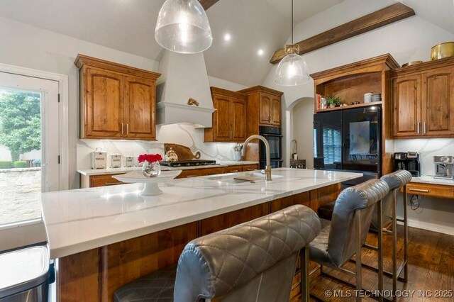 9402 E 109th St S, Tulsa, OK 74133 - kitchen with vaulted ceiling, open shelves, brown cabinets, dark wood finished floors, and arched walkways