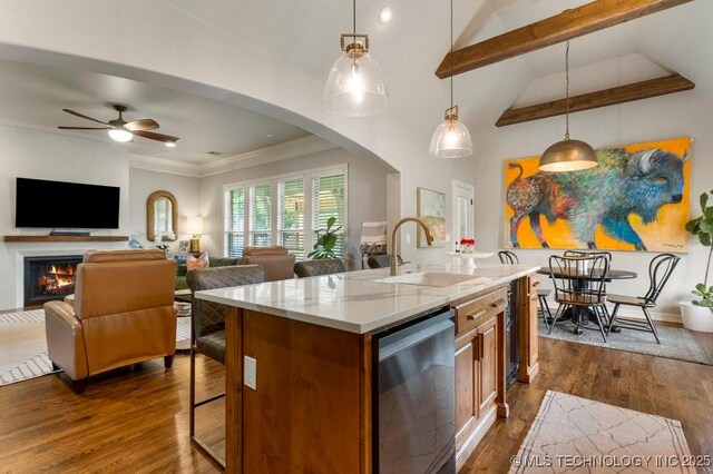 9402 E 109th St S, Tulsa, OK 74133 - kitchen featuring dishwasher, brown cabinetry, arched walkways, open floor plan, and crown molding