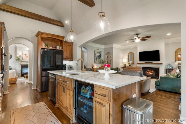 9402 E 109th St S, Tulsa, OK 74133 - kitchen featuring a warm lit fireplace, wine cooler, a kitchen island with sink, a ceiling fan, and recessed lighting