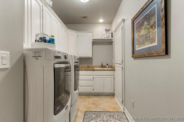 9402 E 109th St S, Tulsa, OK 74133 - laundry room with independent washer and dryer, cabinet space, and light tile patterned floors