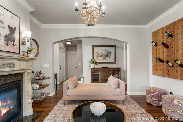 9402 E 109th St S, Tulsa, OK 74133 - living room with a premium fireplace, arched walkways, crown molding, dark wood-type flooring, and a chandelier