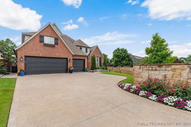 9402 E 109th St S, Tulsa, OK 74133 - traditional-style house featuring brick siding, driveway, and an attached garage
