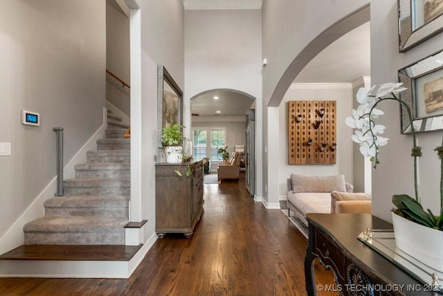 9402 E 109th St S, Tulsa, OK 74133 - foyer with arched walkways, wood finished floors, stairs, and a high ceiling