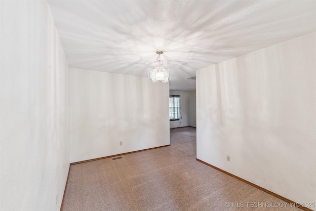 312 W Raleigh Pl, Broken Arrow, OK 74011 - empty room featuring baseboards and a chandelier