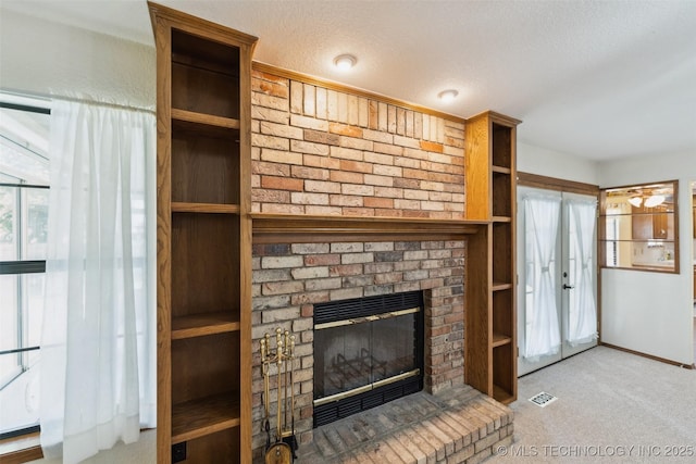 312 W Raleigh Pl, Broken Arrow, OK 74011 - unfurnished living room featuring carpet, a brick fireplace, and a textured ceiling