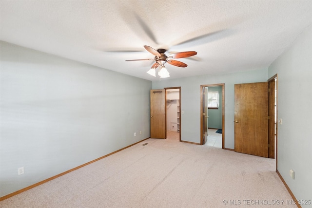 312 W Raleigh Pl, Broken Arrow, OK 74011 - unfurnished bedroom with a spacious closet, light colored carpet, ceiling fan, and a closet