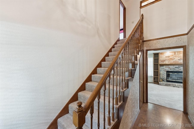 312 W Raleigh Pl, Broken Arrow, OK 74011 - stairs with a brick fireplace