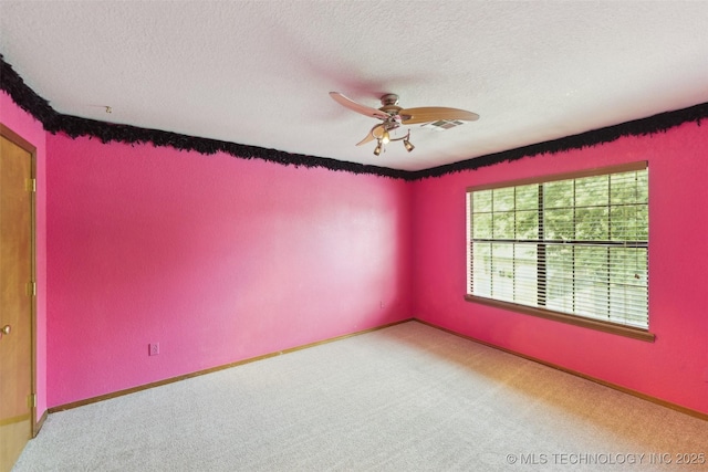 312 W Raleigh Pl, Broken Arrow, OK 74011 - spare room featuring carpet floors, a ceiling fan, and a textured ceiling