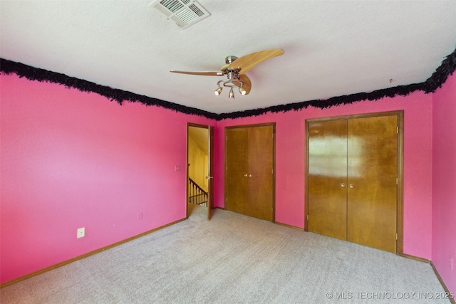 312 W Raleigh Pl, Broken Arrow, OK 74011 - unfurnished bedroom featuring carpet flooring, two closets, and a ceiling fan