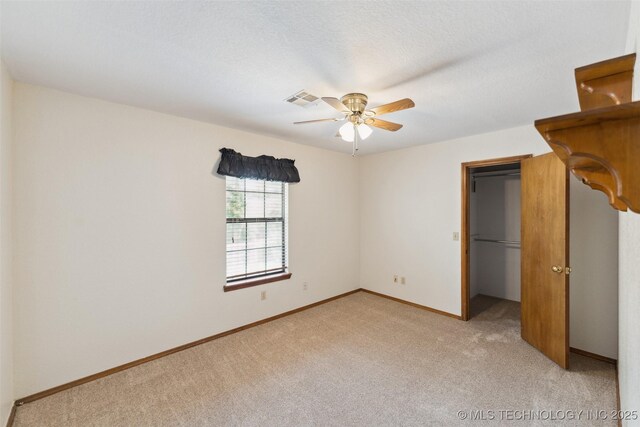 312 W Raleigh Pl, Broken Arrow, OK 74011 - unfurnished bedroom with light colored carpet, a spacious closet, and ceiling fan