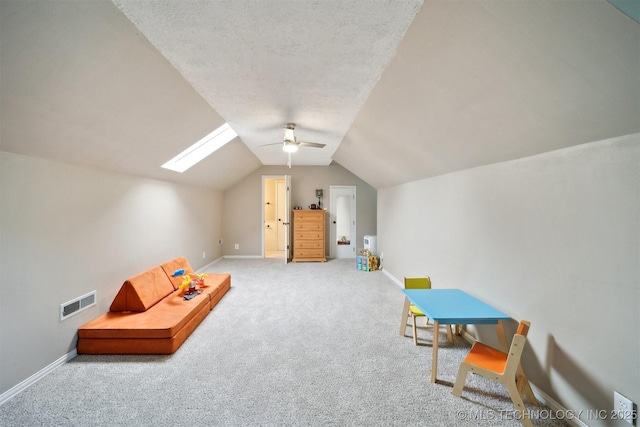 9065 E Prairie View Dr, Claremore, OK 74019 - recreation room featuring carpet, vaulted ceiling, a skylight, and a ceiling fan