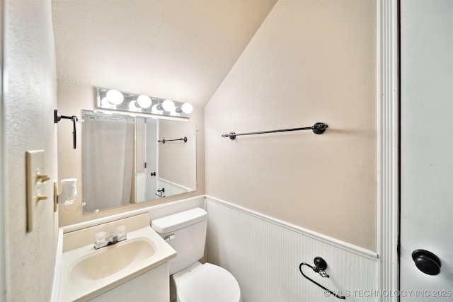 9065 E Prairie View Dr, Claremore, OK 74019 - bathroom featuring lofted ceiling, a wainscoted wall, a shower with shower curtain, and vanity