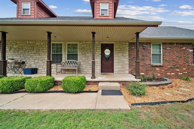 9065 E Prairie View Dr, Claremore, OK 74019 - property entrance with covered porch, roof with shingles, and stone siding
