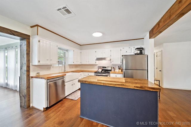9065 E Prairie View Dr, Claremore, OK 74019 - kitchen featuring stainless steel appliances, wood counters, under cabinet range hood, and white cabinetry