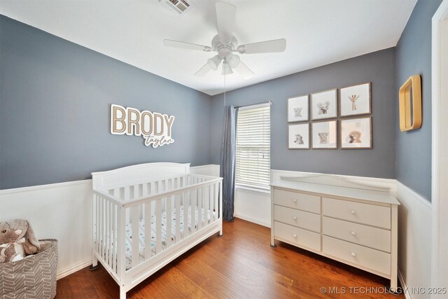 9065 E Prairie View Dr, Claremore, OK 74019 - bedroom featuring wood finished floors, a nursery area, and a ceiling fan
