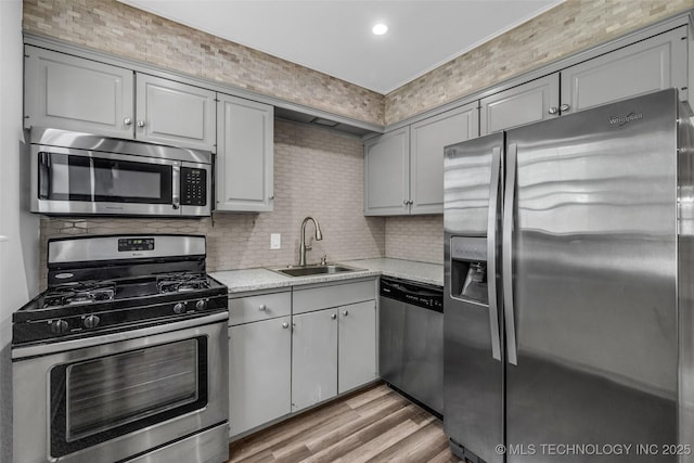4517 S Peoria Ave Unit 31A, Tulsa, OK 74105 - kitchen featuring appliances with stainless steel finishes, light countertops, backsplash, light wood finished floors, and recessed lighting