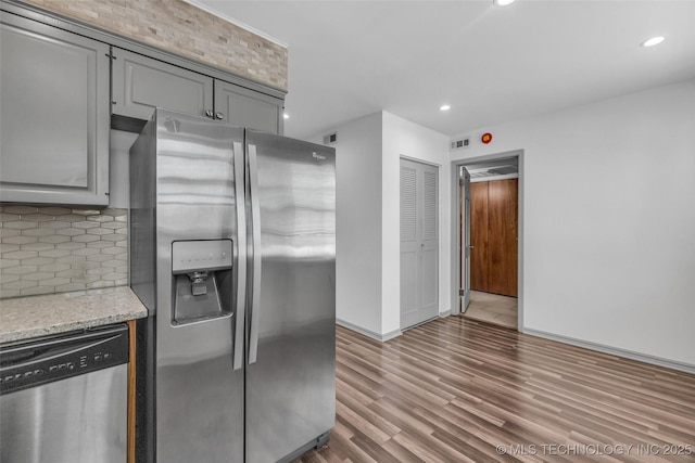 4517 S Peoria Ave Unit 31A, Tulsa, OK 74105 - kitchen featuring appliances with stainless steel finishes, tasteful backsplash, gray cabinets, recessed lighting, and light stone countertops