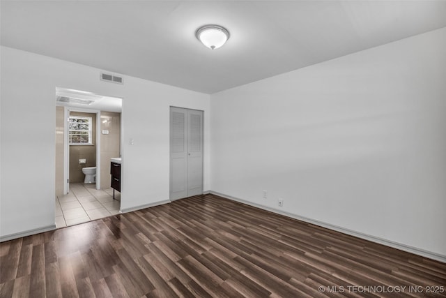4517 S Peoria Ave Unit 31A, Tulsa, OK 74105 - unfurnished bedroom with wood finished floors, a closet, and ensuite bath