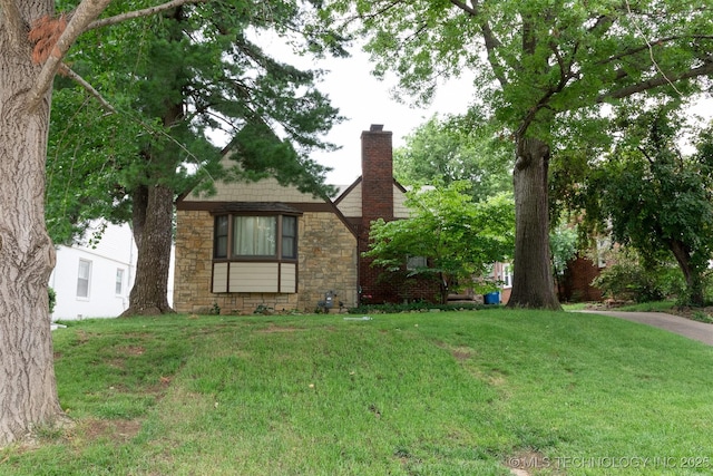 3524 E 12th Pl, Tulsa, OK 74112 - view of front facade featuring a chimney, stone siding, and a front yard