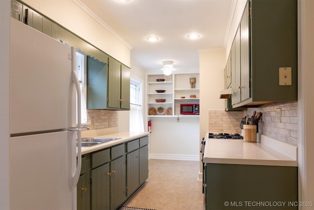 3524 E 12th Pl, Tulsa, OK 74112 - kitchen featuring freestanding refrigerator, stainless steel microwave, under cabinet range hood, tasteful backsplash, and crown molding