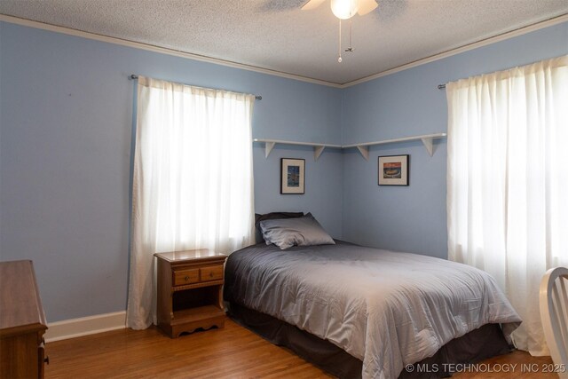 3524 E 12th Pl, Tulsa, OK 74112 - bedroom with wood finished floors, a textured ceiling, crown molding, and ceiling fan