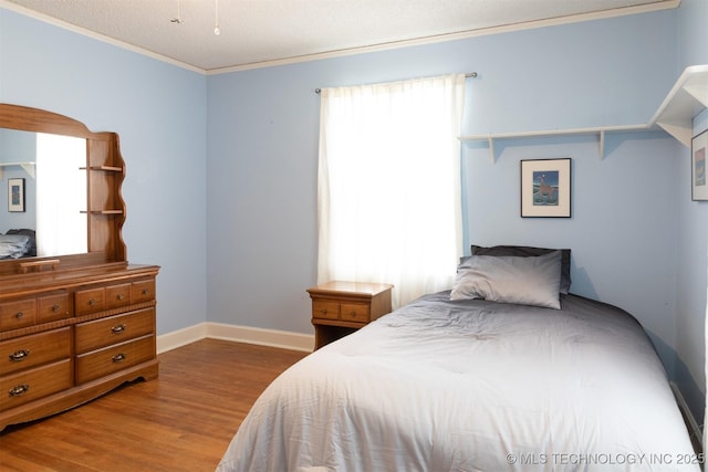 3524 E 12th Pl, Tulsa, OK 74112 - bedroom with wood finished floors and crown molding