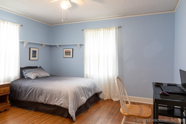 3524 E 12th Pl, Tulsa, OK 74112 - bedroom featuring wood finished floors, multiple windows, crown molding, a textured ceiling, and a ceiling fan