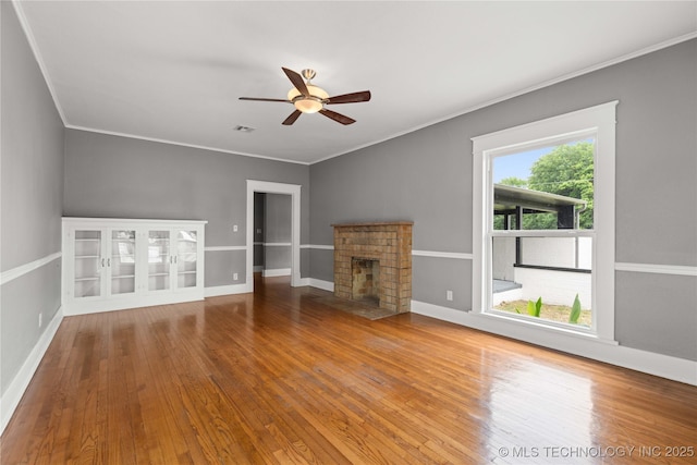 575 N 7th St, Muskogee, OK 74401 - unfurnished living room with wood-type flooring, ceiling fan, crown molding, and a fireplace