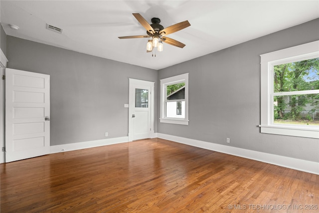 575 N 7th St, Muskogee, OK 74401 - empty room with wood finished floors, a ceiling fan, and a smoke detector