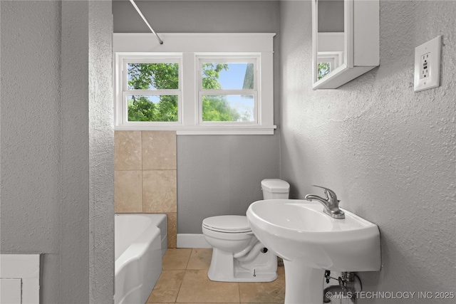 575 N 7th St, Muskogee, OK 74401 - bathroom with tile patterned flooring, a tub to relax in, a textured wall, and a shower