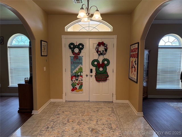 607 Nelson, Mcalester, OK 74501 - entrance foyer with arched walkways, plenty of natural light, and a chandelier