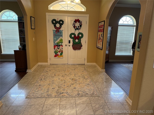 607 Nelson, Mcalester, OK 74501 - entryway featuring arched walkways, plenty of natural light, and marble look tiles